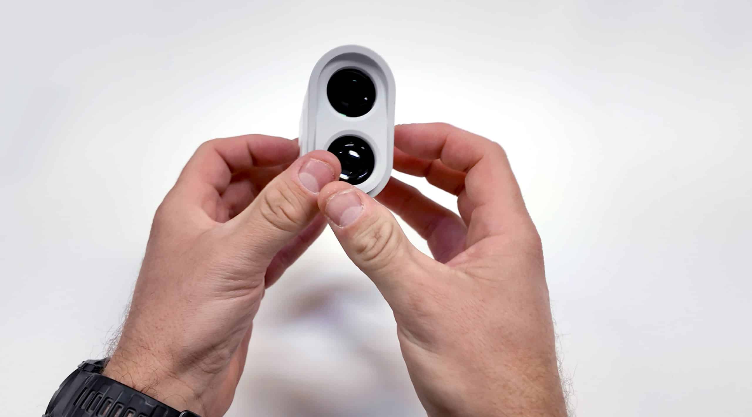 Person holding compact dual-lens action camera