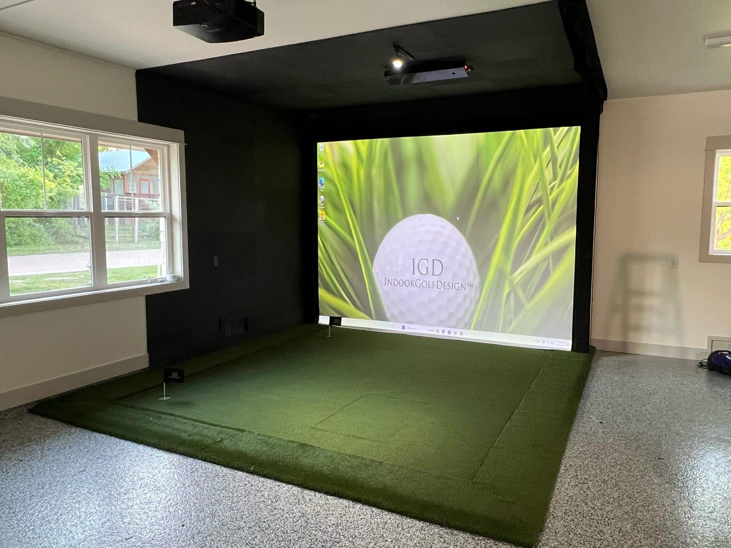 Indoor golf simulator setup with large screen projection