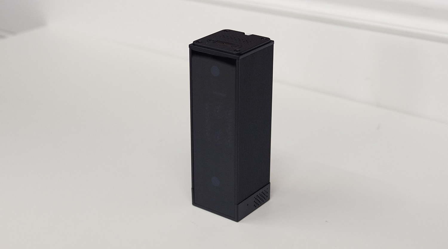 Black rectangular smart speaker on white surface