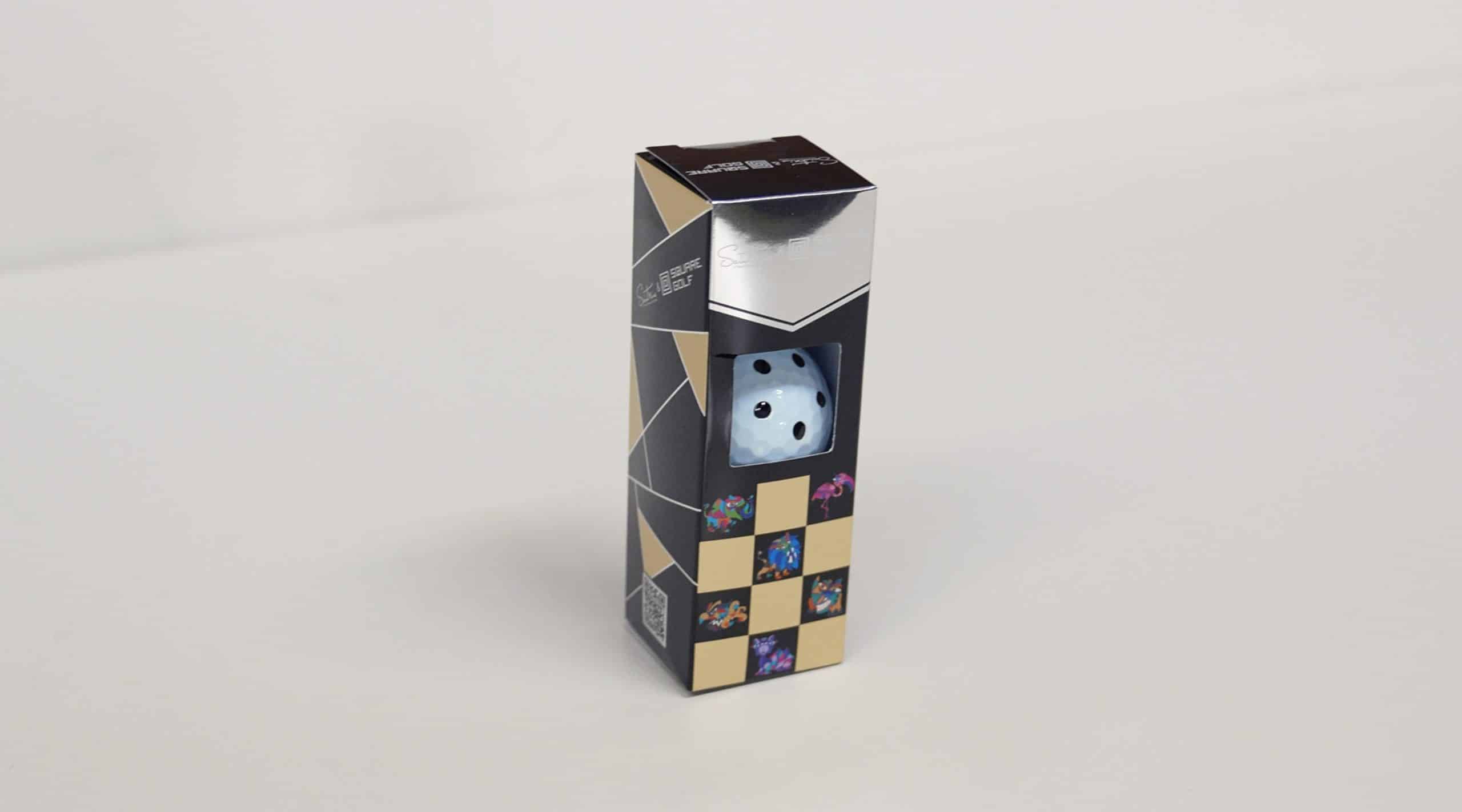 Packaged golf ball with dice design