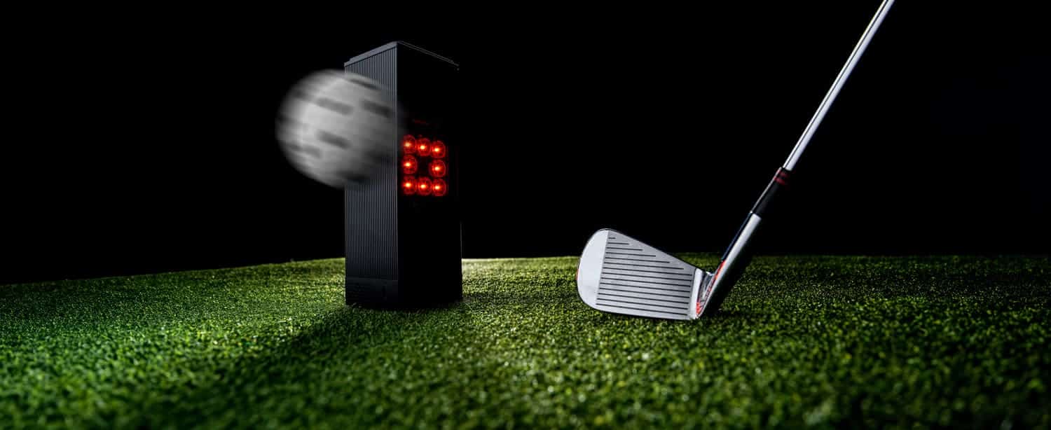Golf club hitting ball with launch monitor