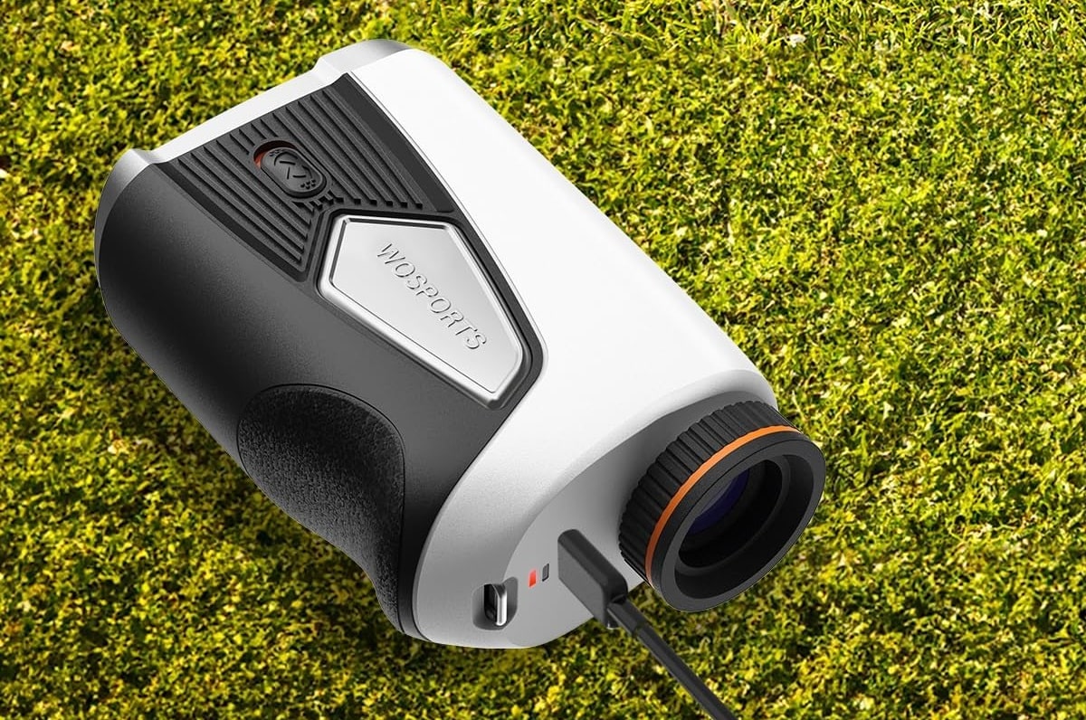 Golf rangefinder charging on grass surface