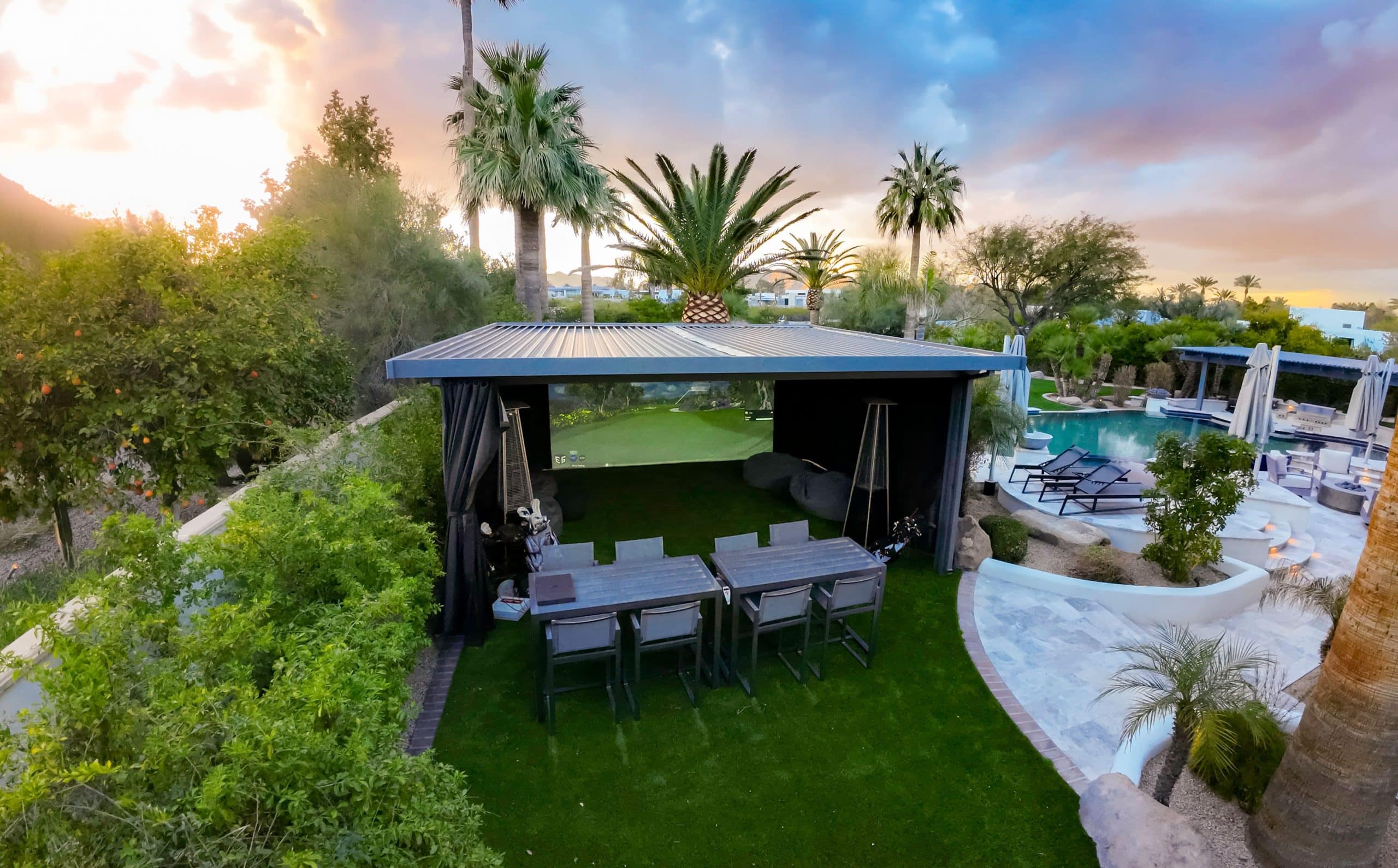 Luxury backyard patio with pool and palm trees