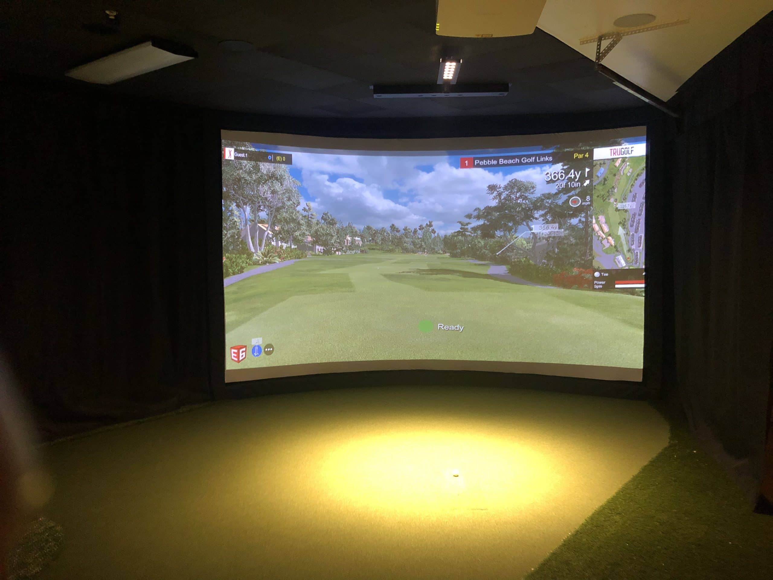 Indoor golf simulator displaying Pebble Beach course