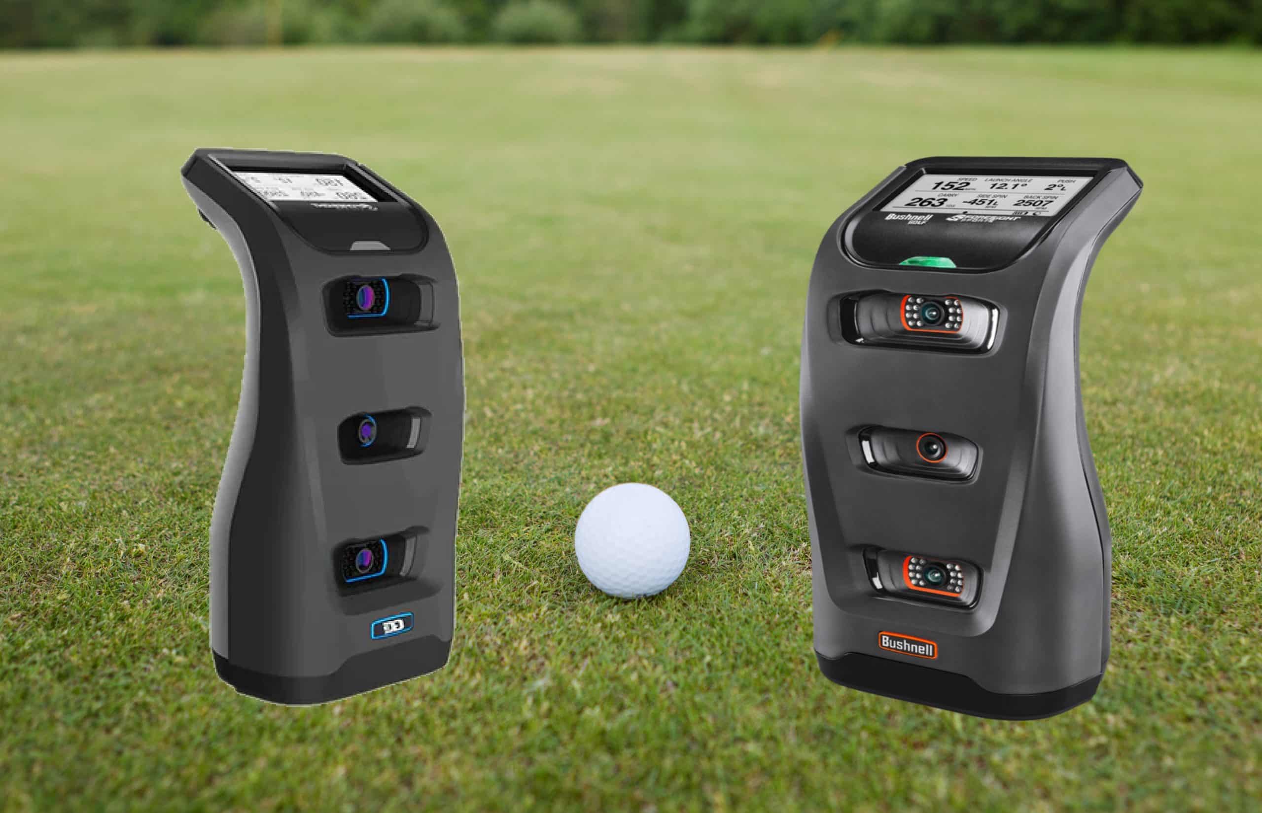 Golf launch monitors beside a golf ball on grass