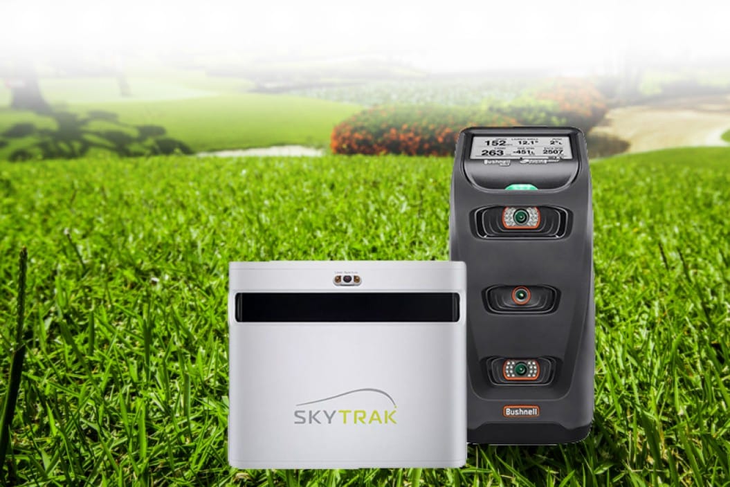 Golf launch monitors on a grassy field