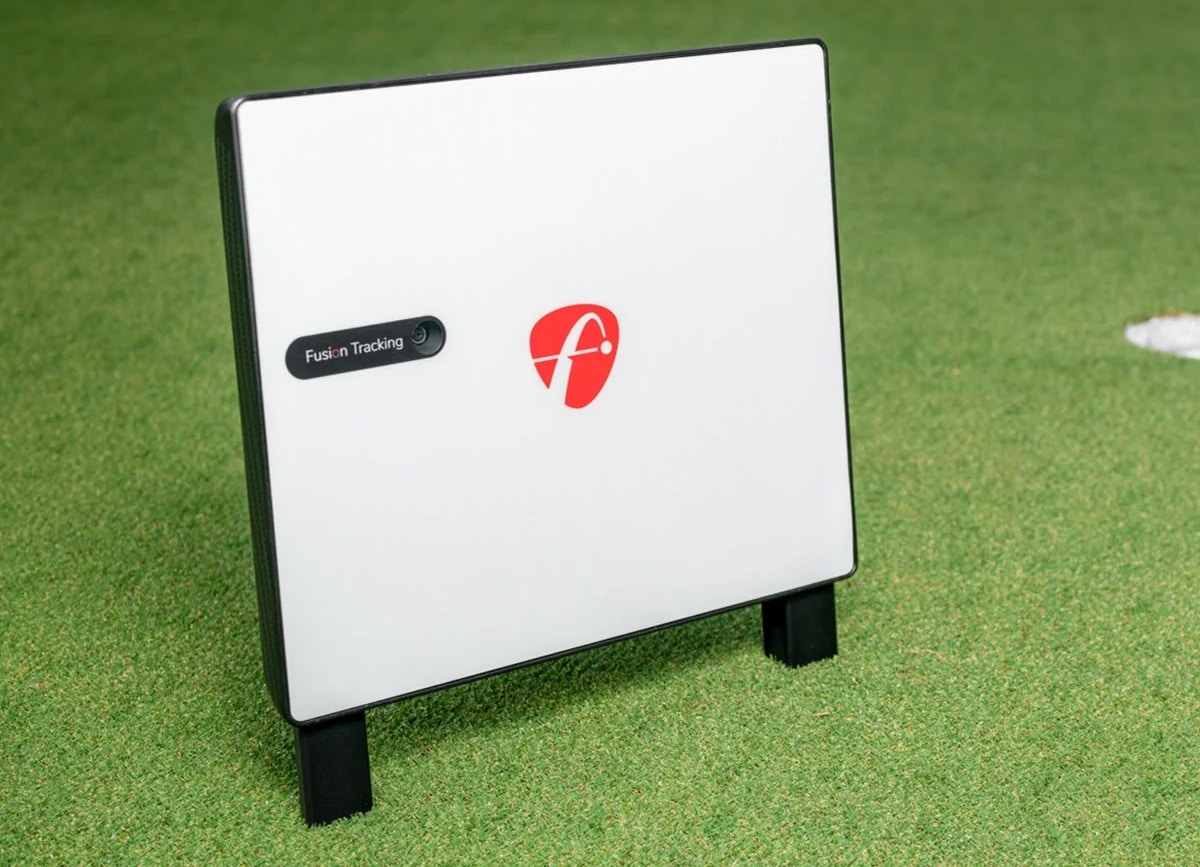 Golf launch monitor on green grass