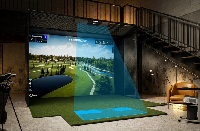 Indoor golf simulator setup under staircase