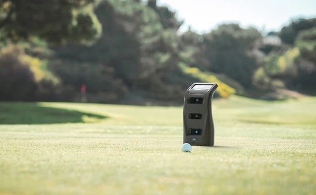 Golf ball and launch monitor on course grass