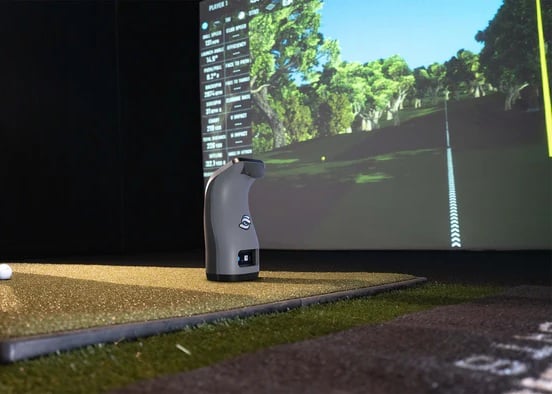 Golf simulator tracking device on indoor green