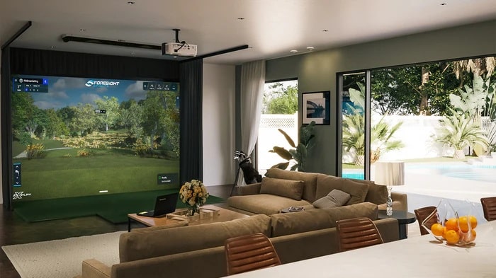 Modern living room with golf simulator and pool view