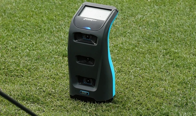 Sports radar tracking device on grass field