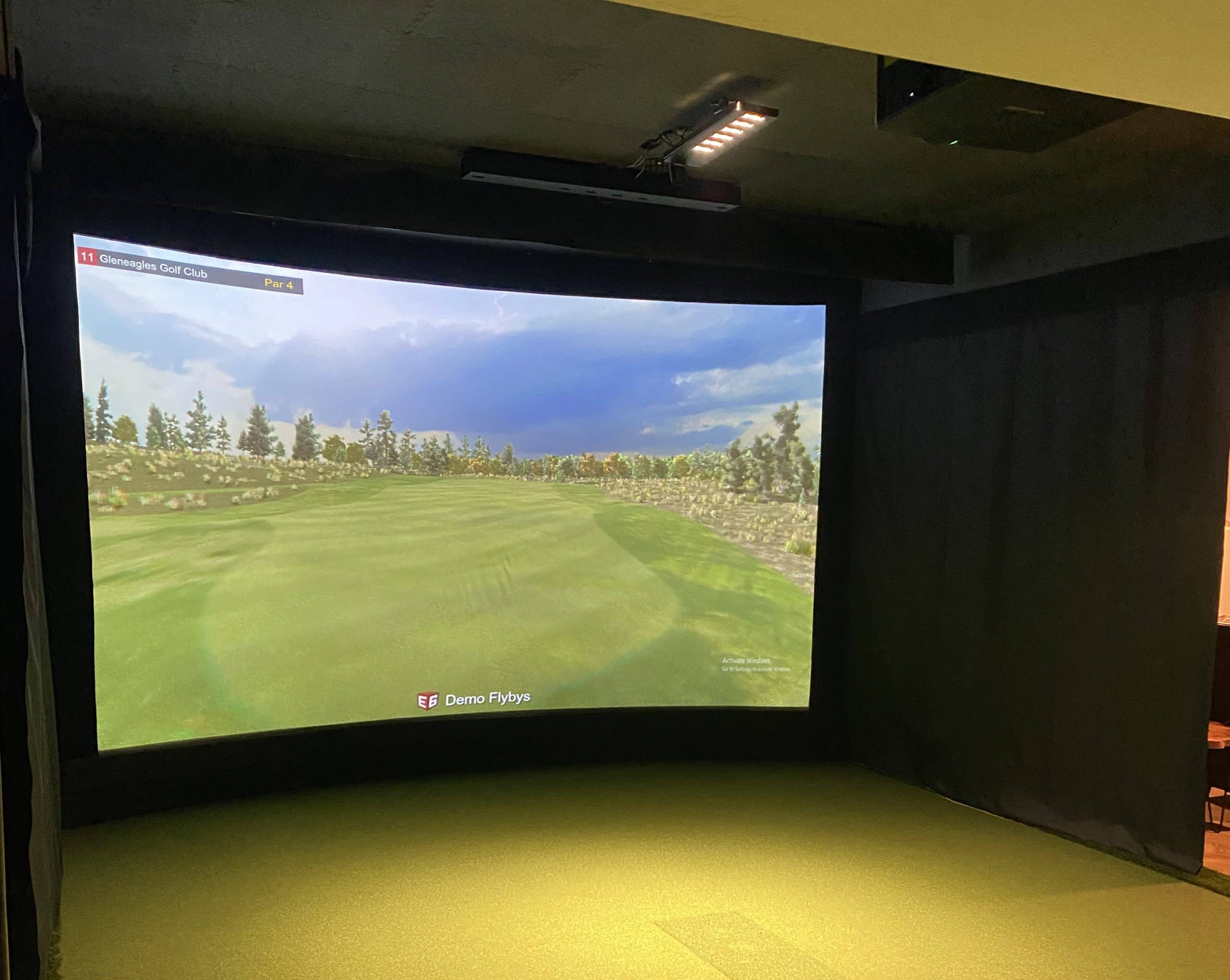 Indoor golf simulator showing Gleneagles Golf Club course