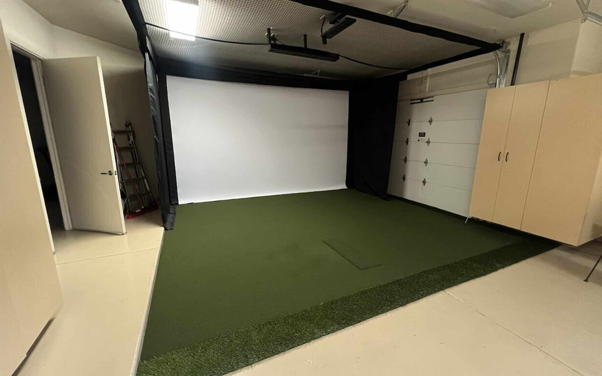 Indoor golf simulator setup in a garage