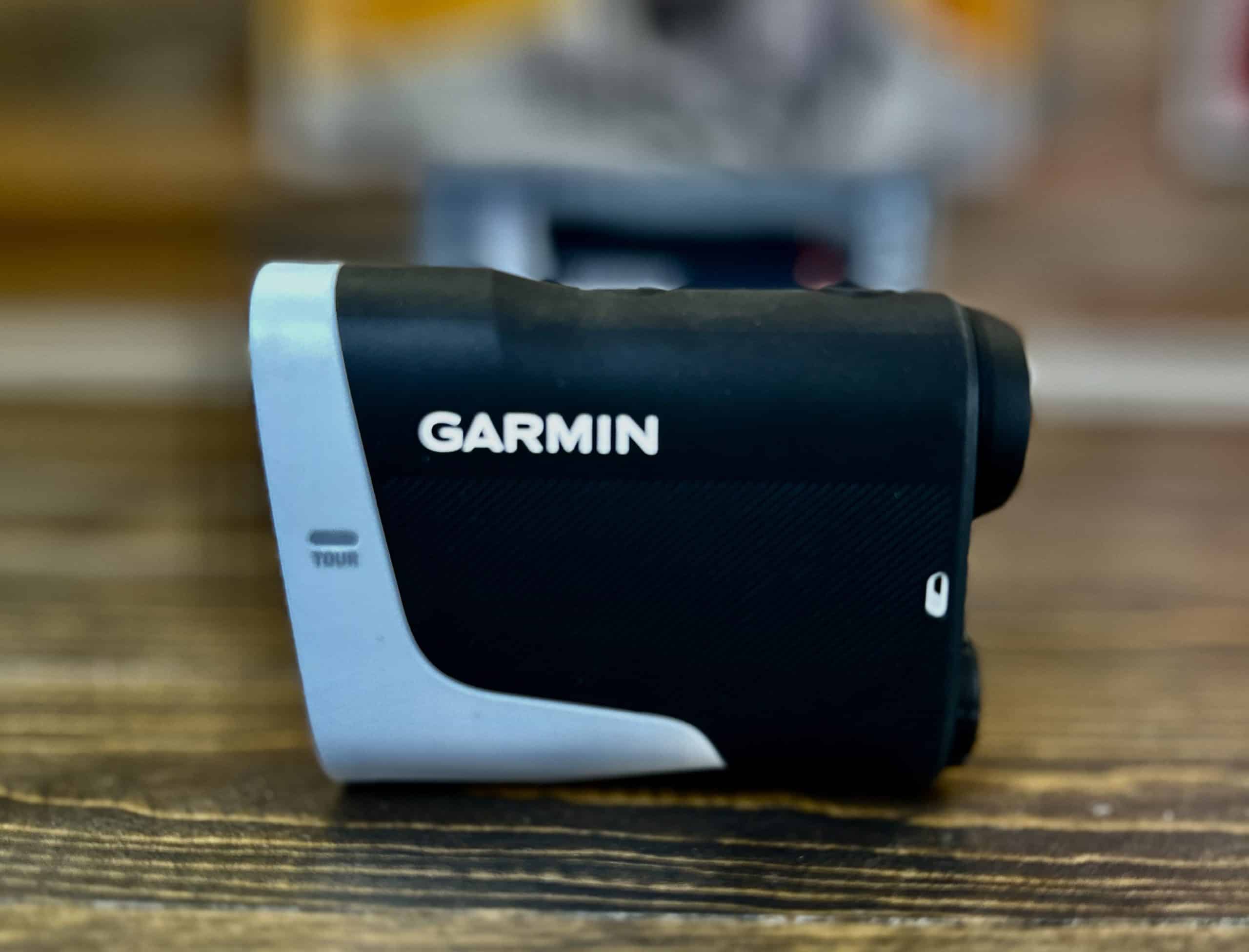 Garmin golf rangefinder on wooden surface