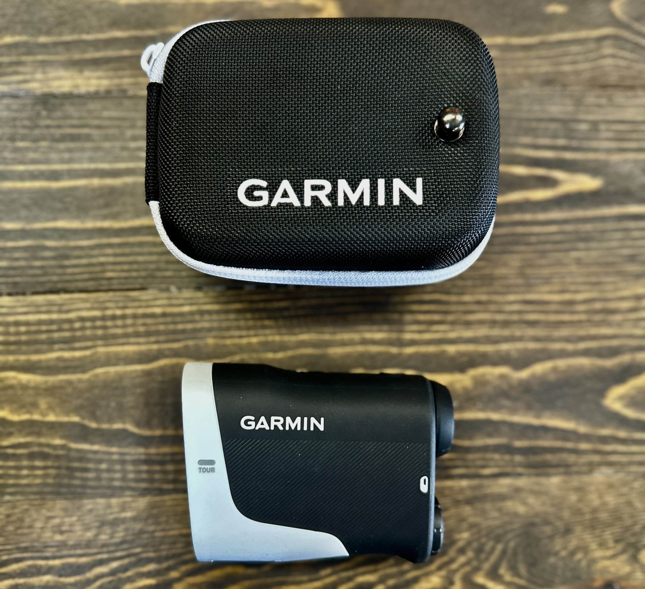 Garmin rangefinder with protective carrying case on table