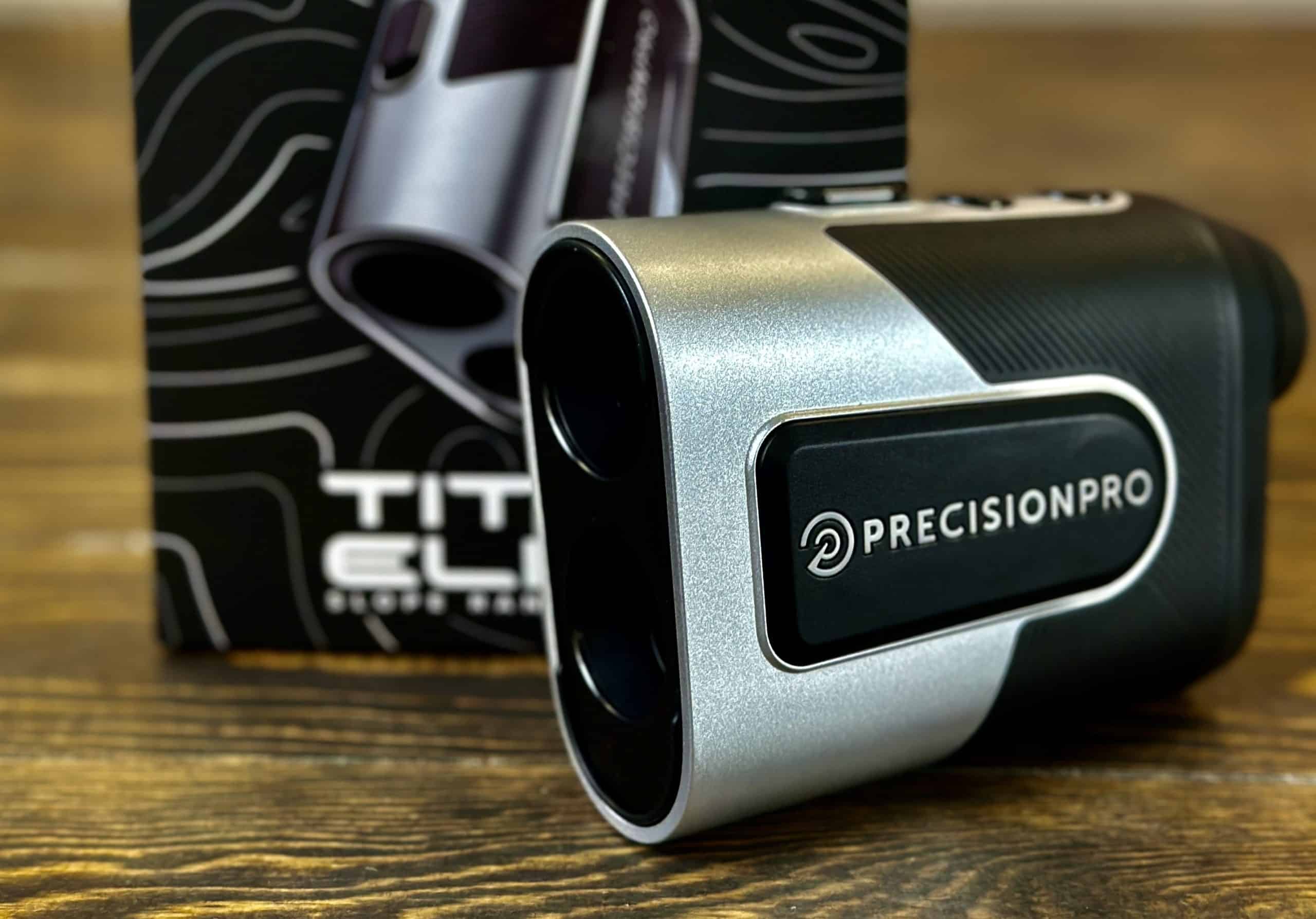 Precision Pro golf rangefinder on wooden table