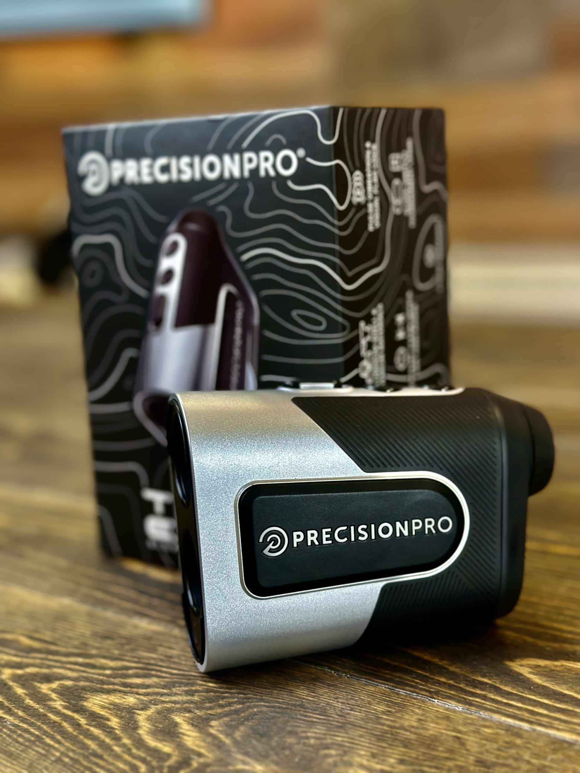Precision Pro golf rangefinder with box on table
