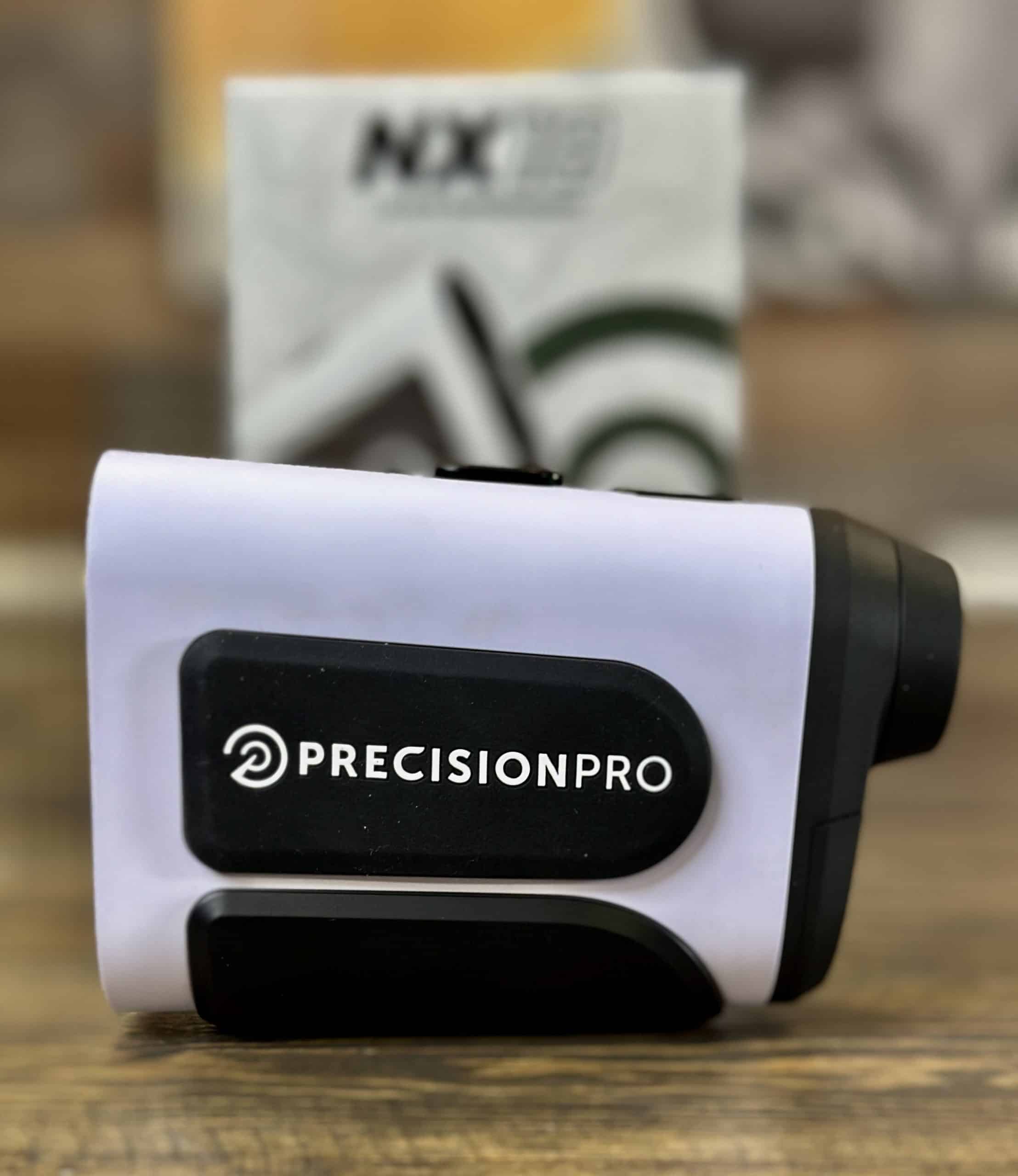 Precision Pro golf rangefinder on wooden surface