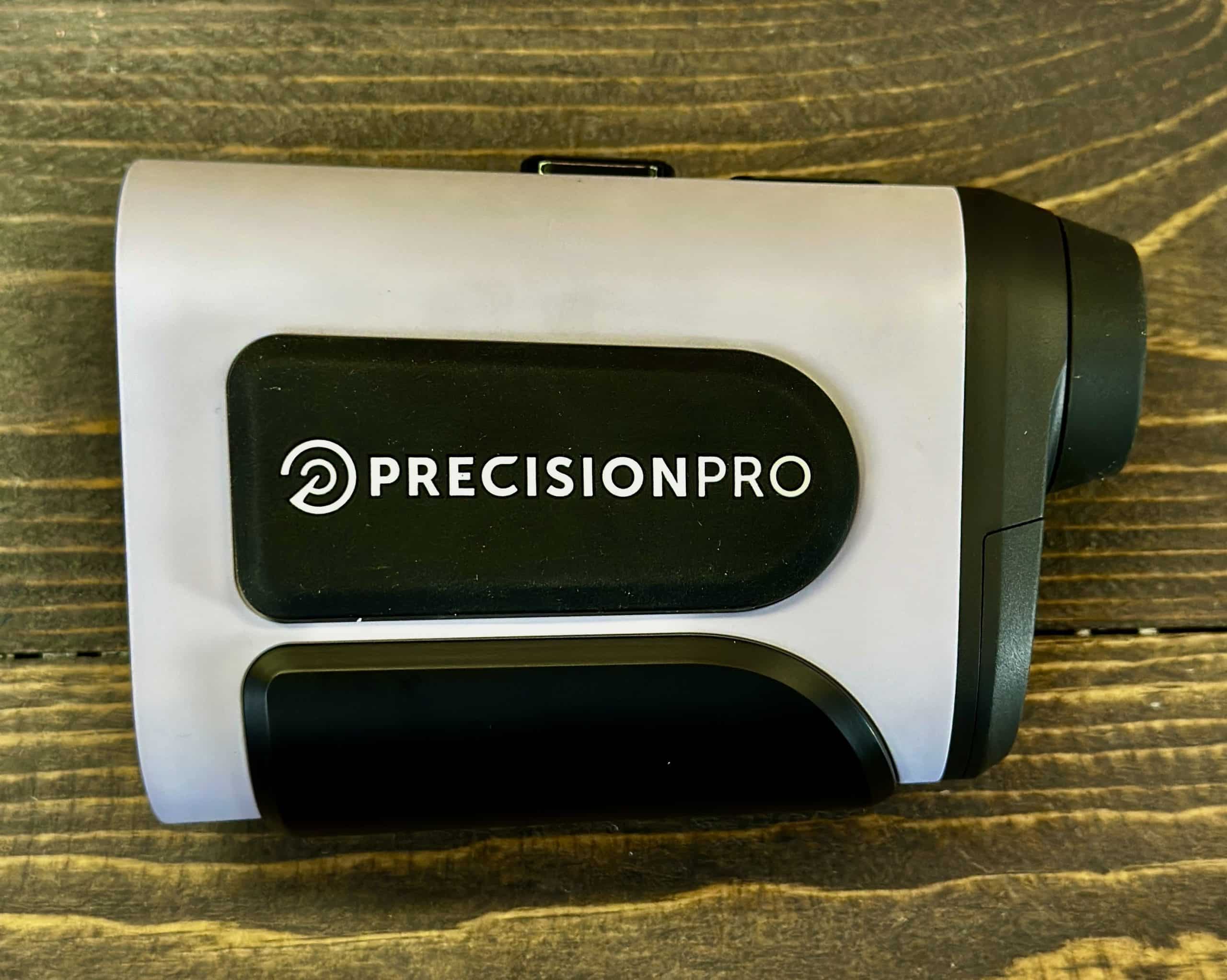 Precision Pro golf rangefinder on wooden surface