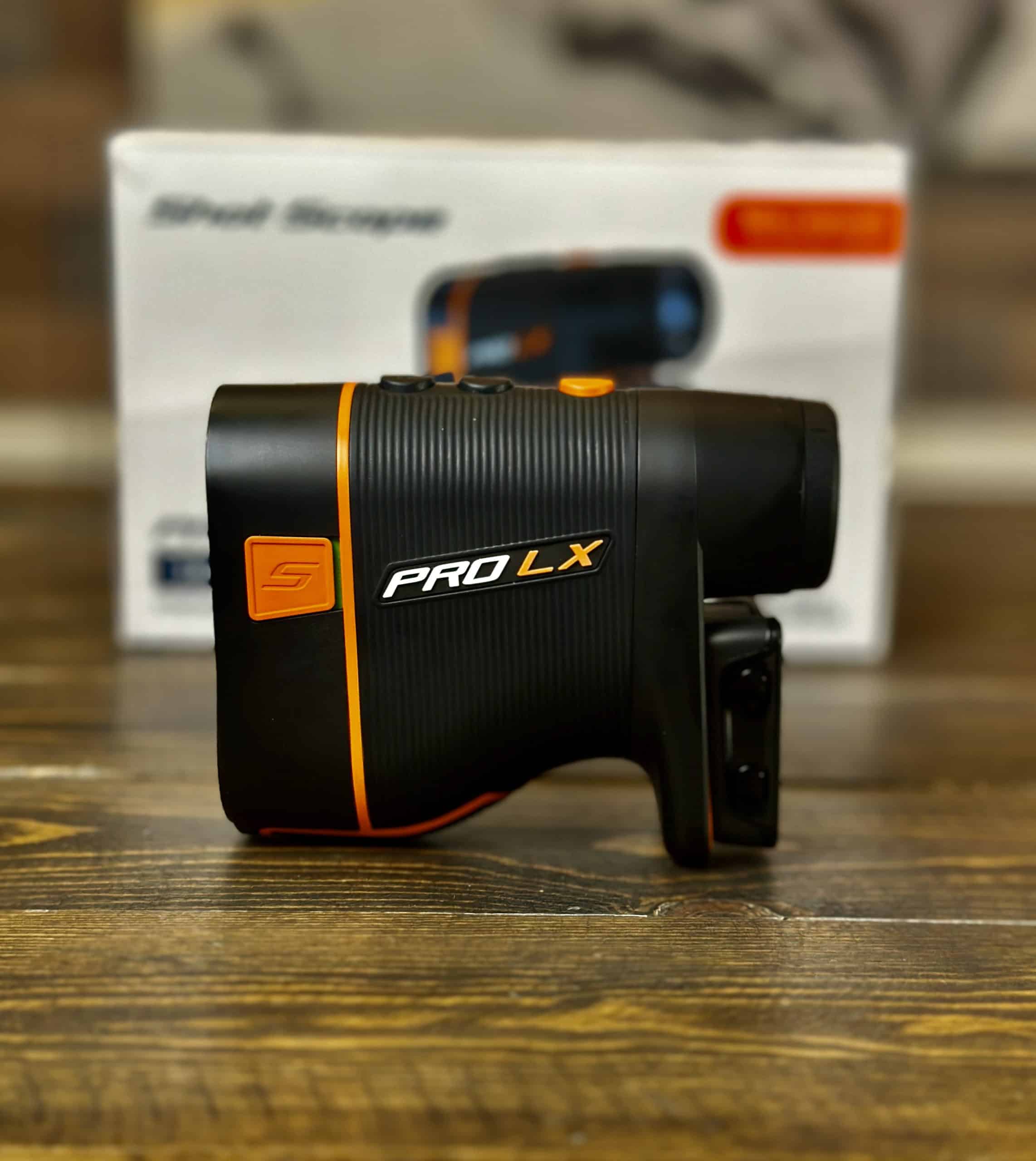 PRO LX golf rangefinder on wooden surface
