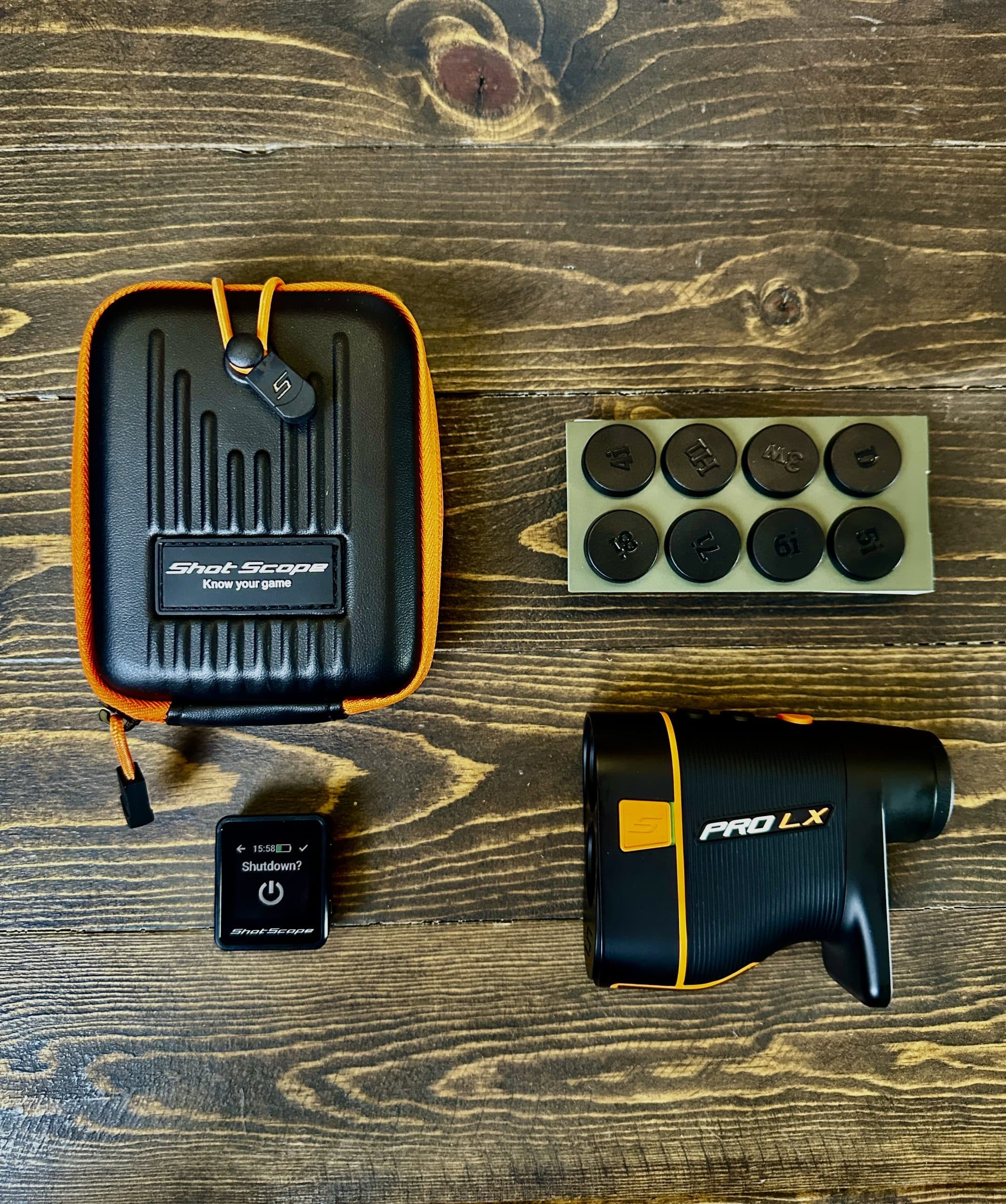 Shot Scope PRO LX golf rangefinder set on wooden table