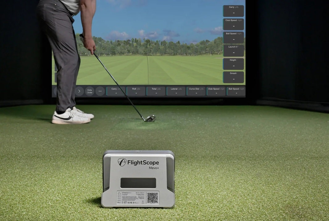 Golfer using FlightScope Mevo+ golf simulator indoors
