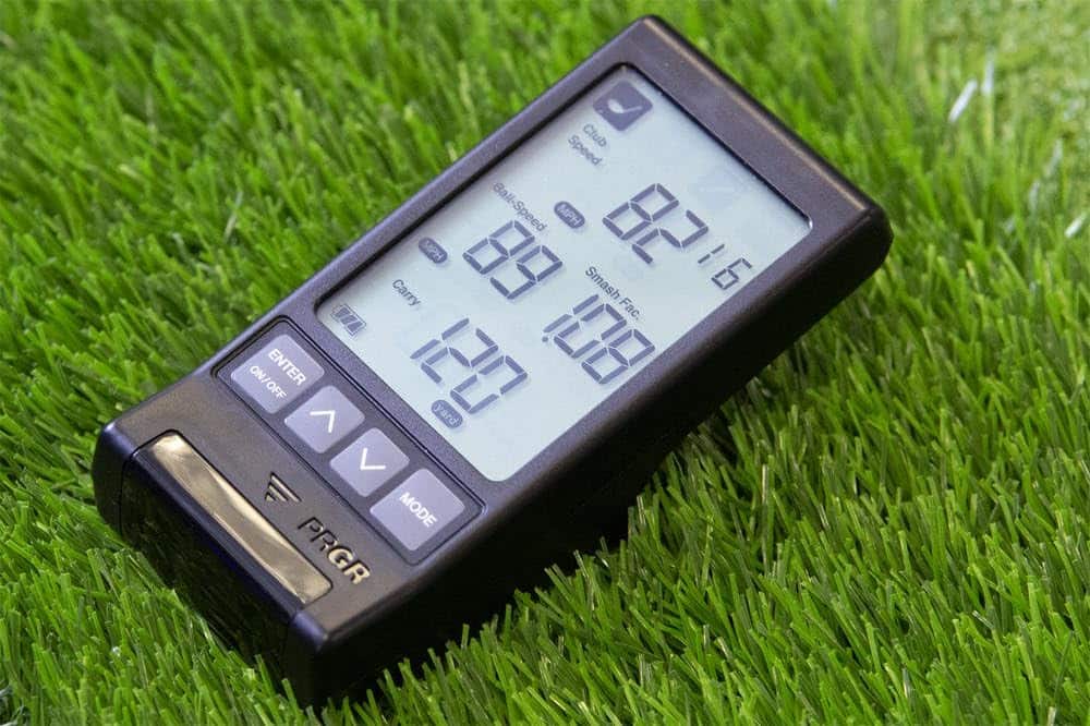 Golf launch monitor on artificial grass surface