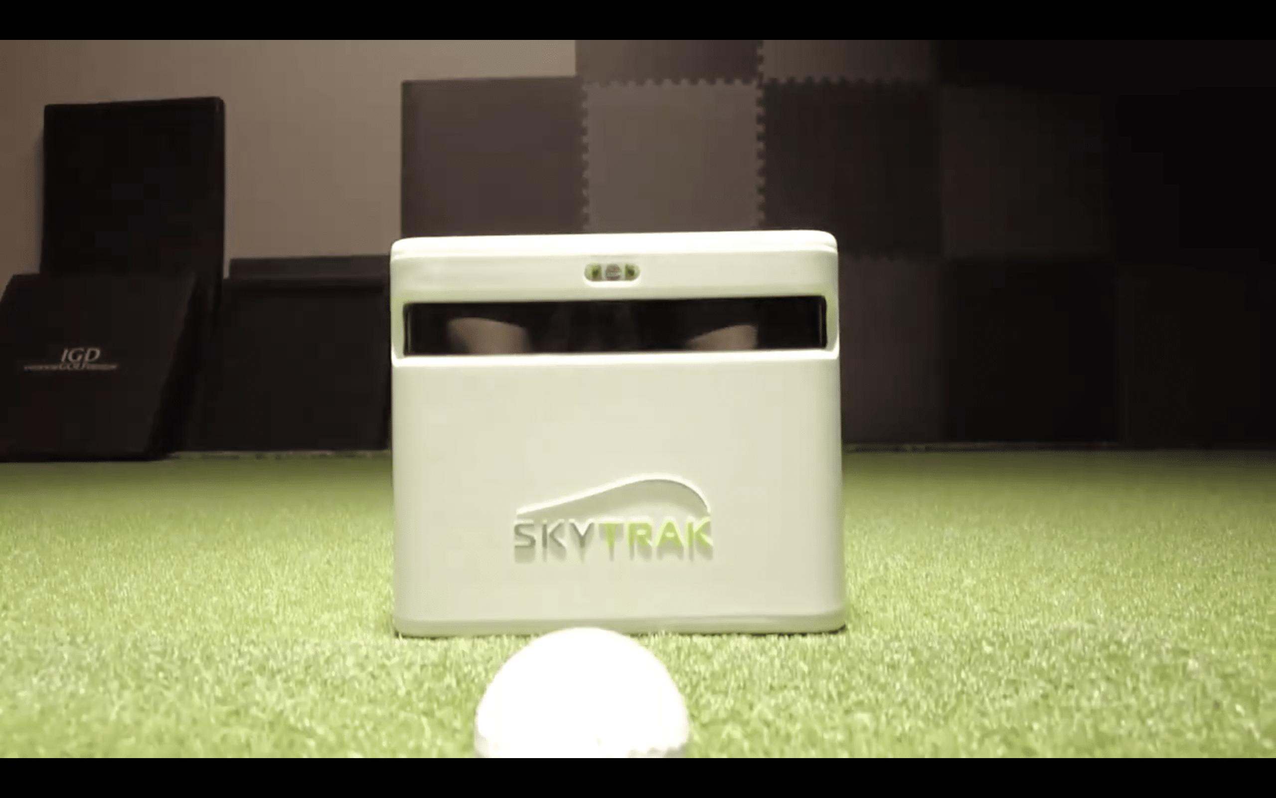 SkyTrak golf launch monitor on indoor turf