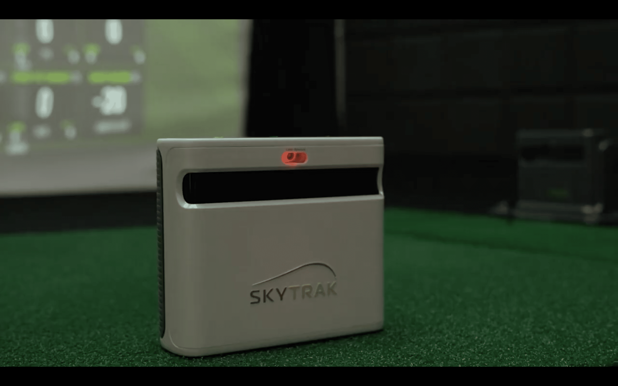 SkyTrak golf launch monitor on green mat