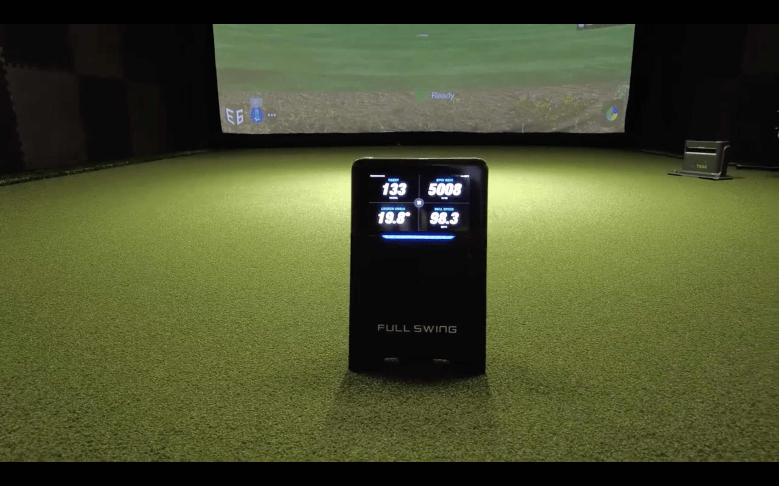 Full Swing golf simulator showing swing data indoors