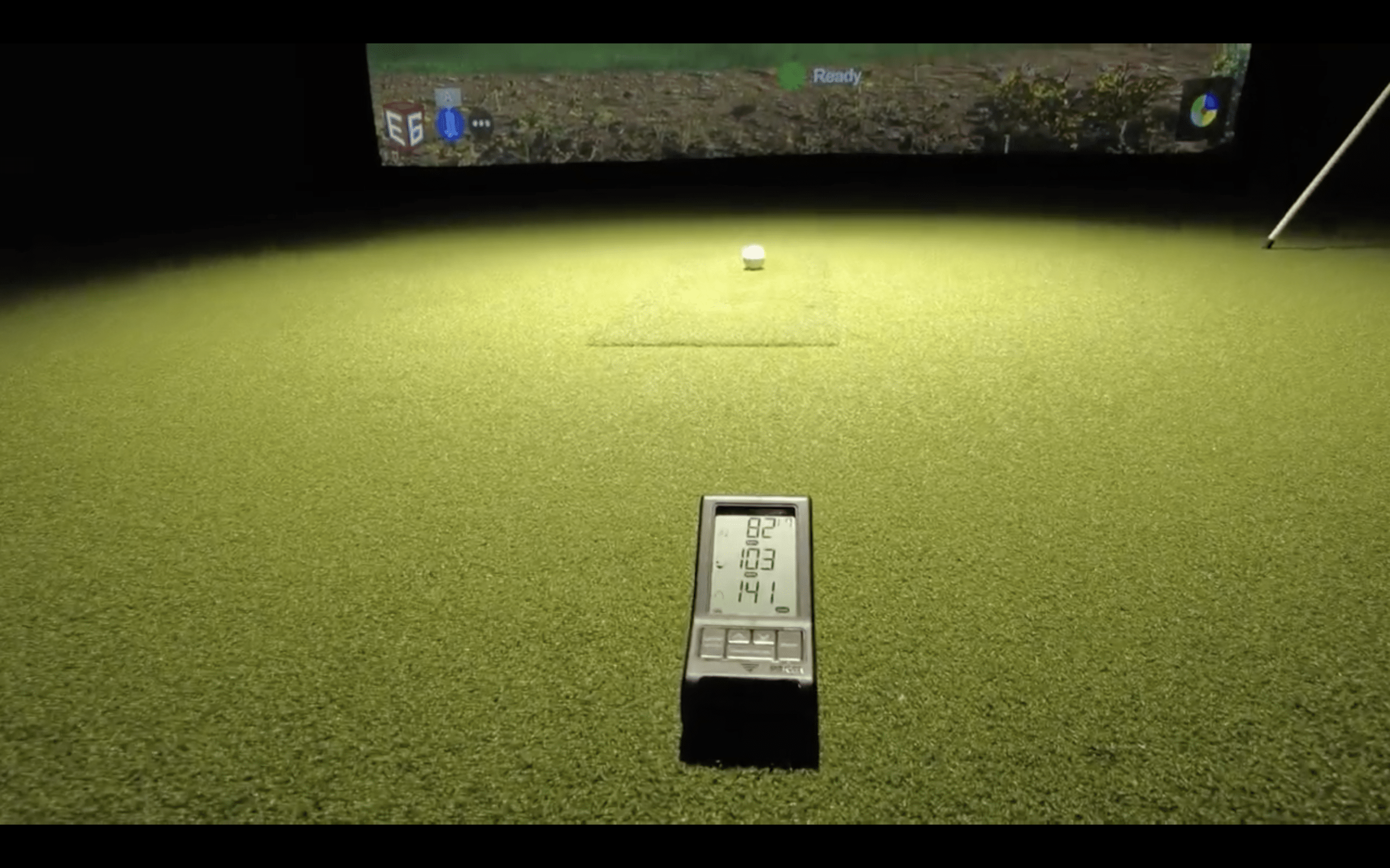 Golf simulator setup with ball and launch monitor