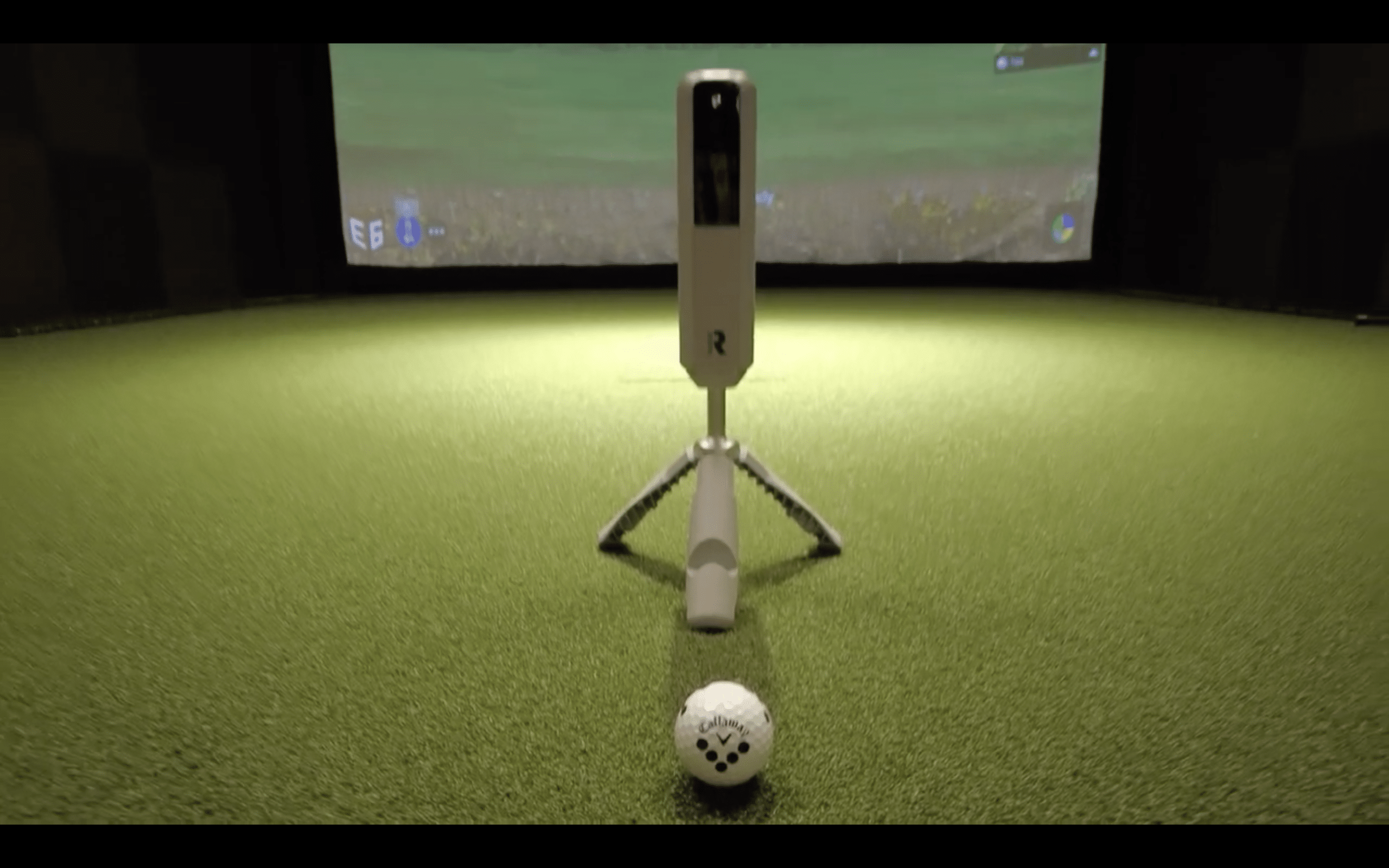 Golf simulator setup with ball and launch monitor