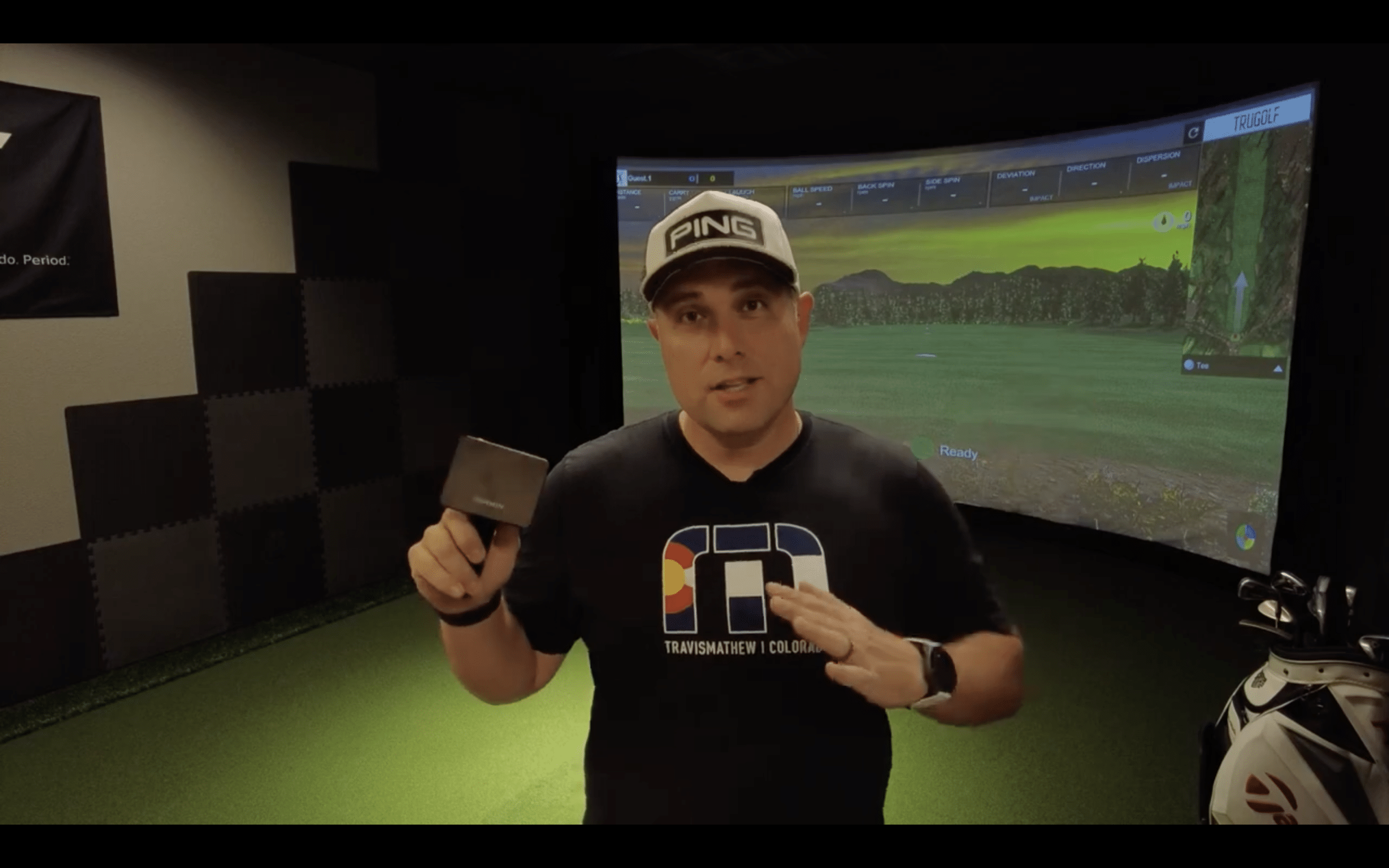 Man demonstrating golf simulator indoors