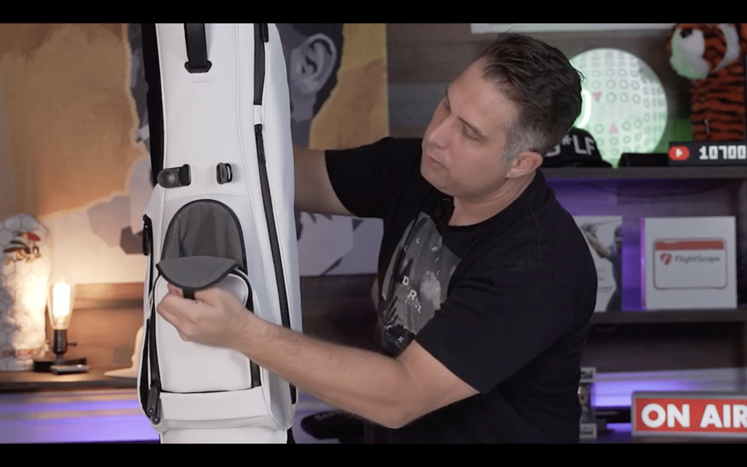 Man showing features of a golf bag