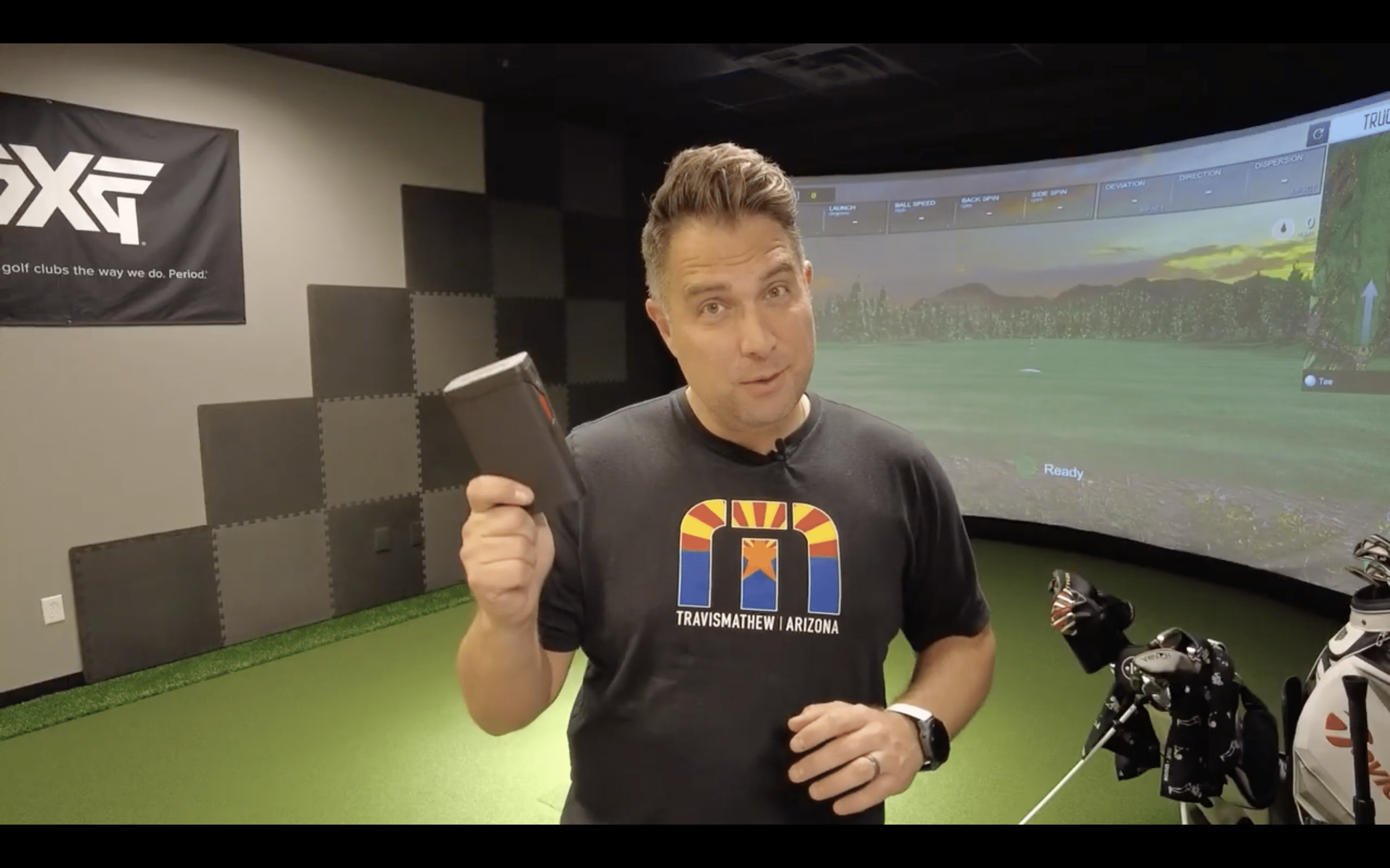 Man presenting golf equipment indoors