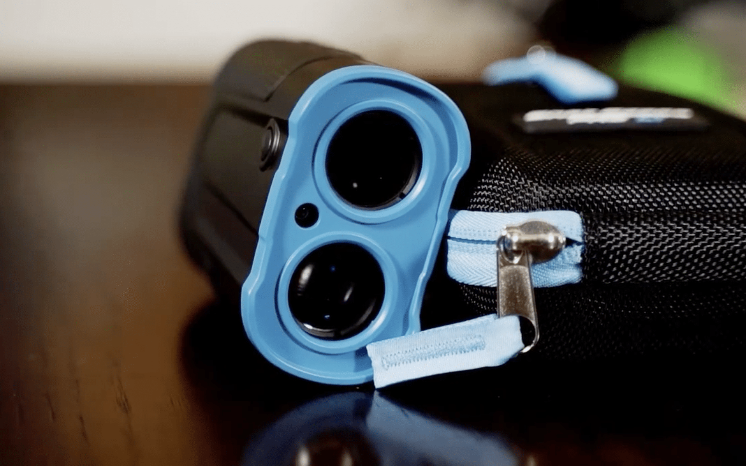 Blue handheld rangefinder with protective carrying case