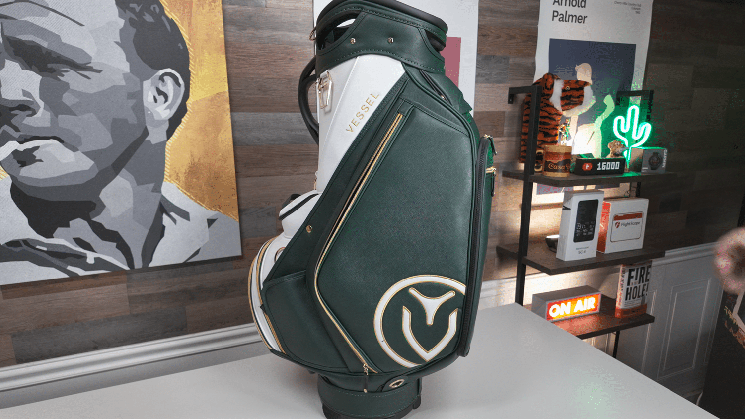 Green and white Vessel golf bag on display table