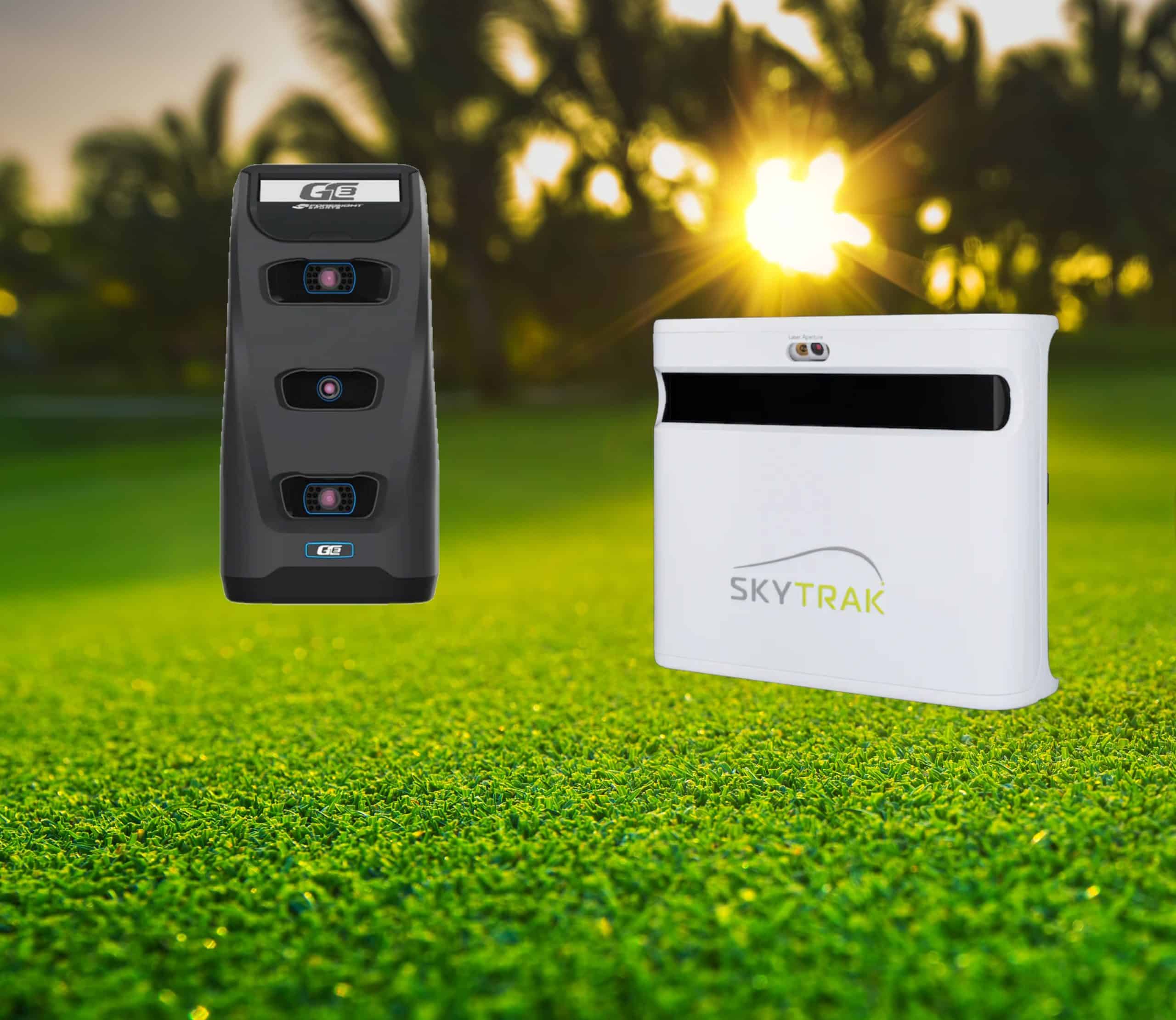 Golf launch monitors on green field at sunset