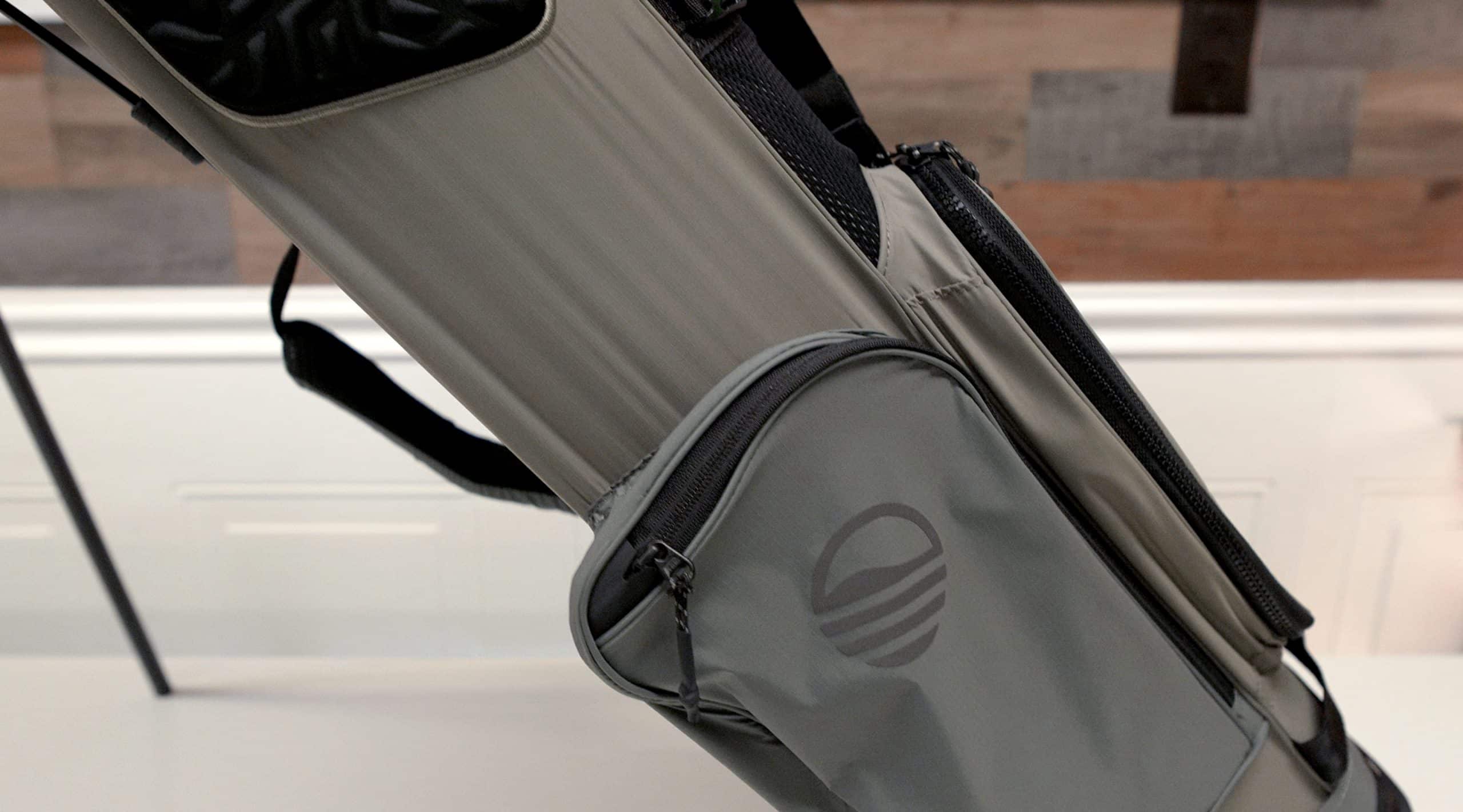 Gray golf bag with side pocket and strap