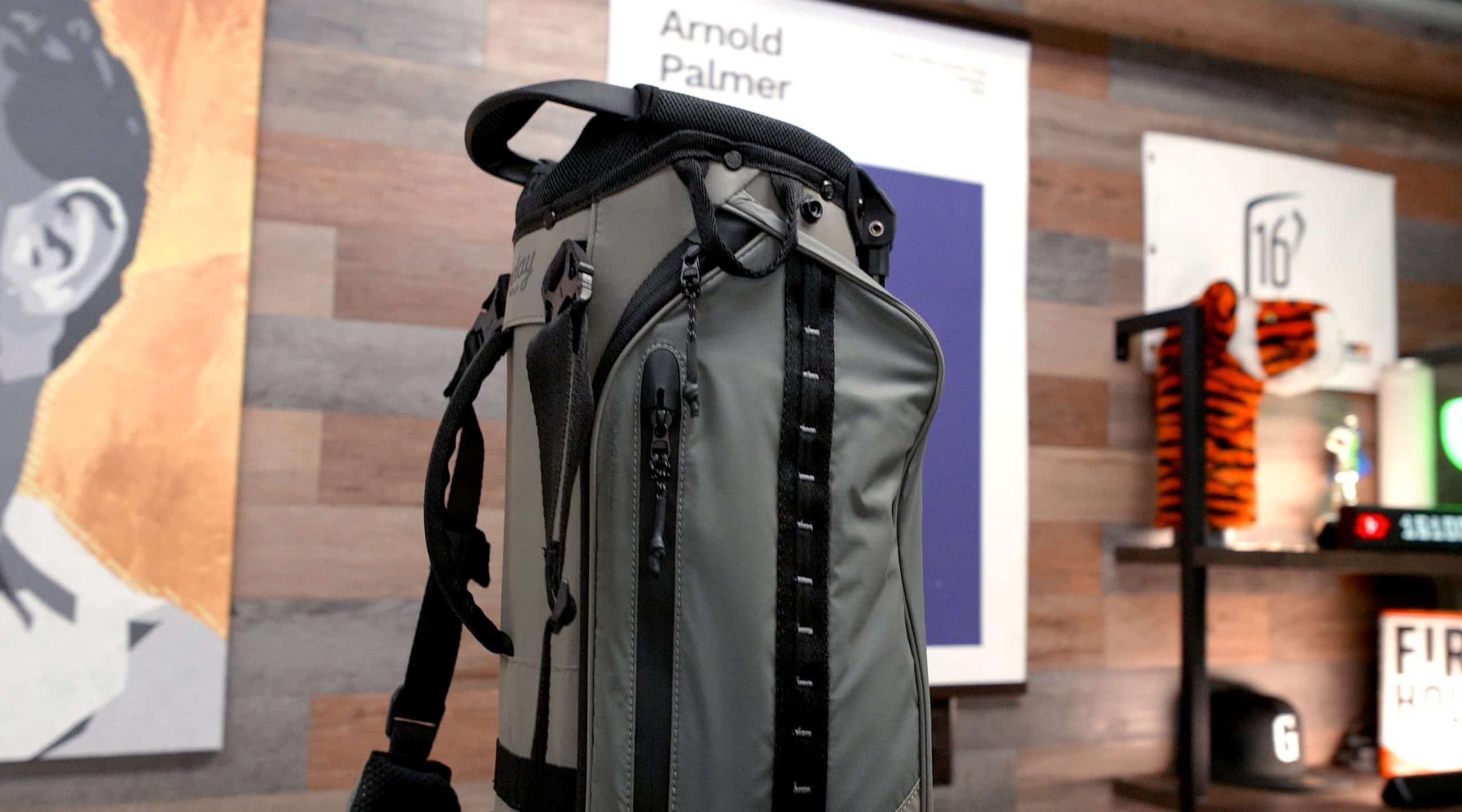 Gray golf bag displayed indoors on shelf
