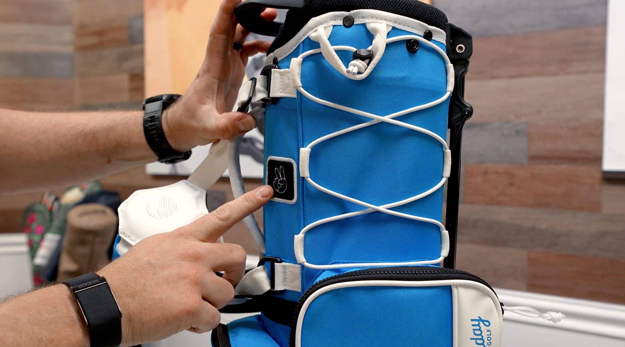 Person showing blue golf bag details