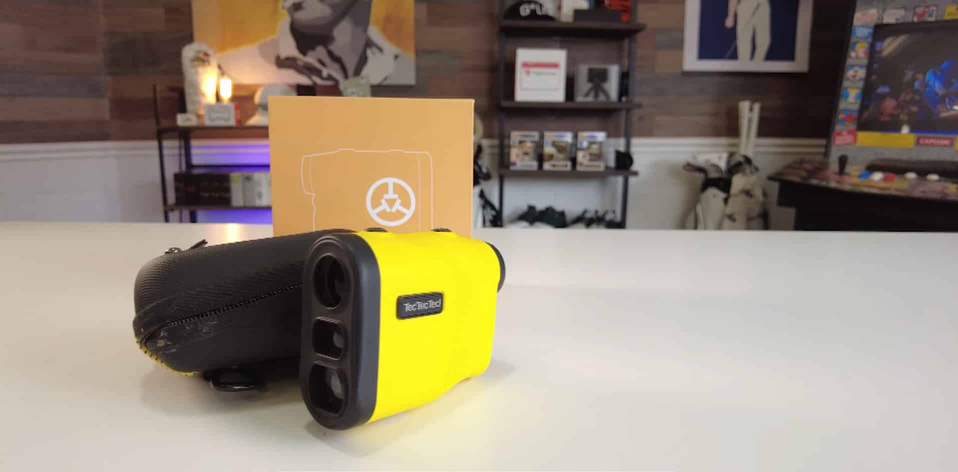 Yellow TecTecTec rangefinder on a white table