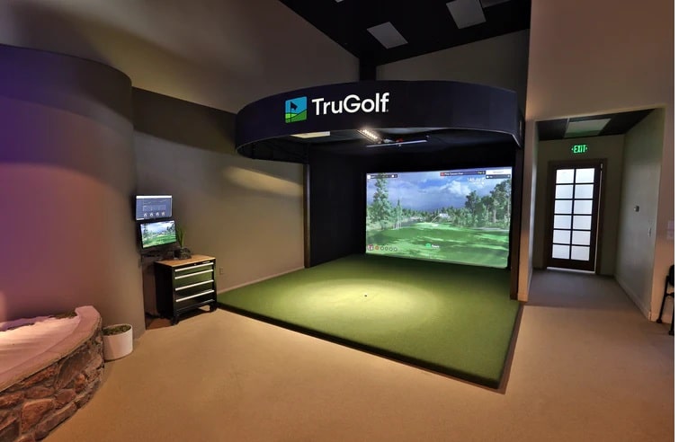 Indoor TruGolf simulator with green turf setup