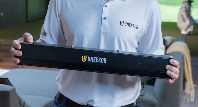 Person holding Uneekor golf launch monitor