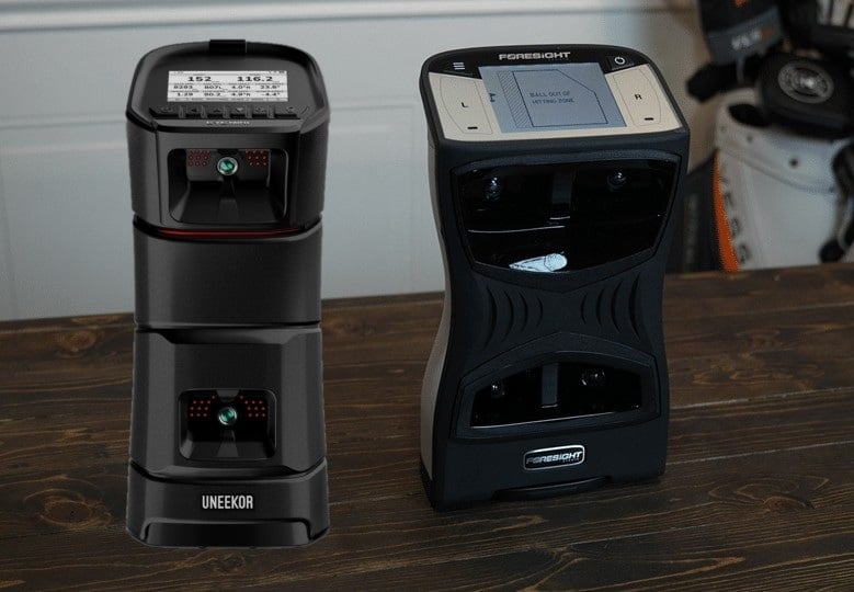 Golf launch monitors on wooden table