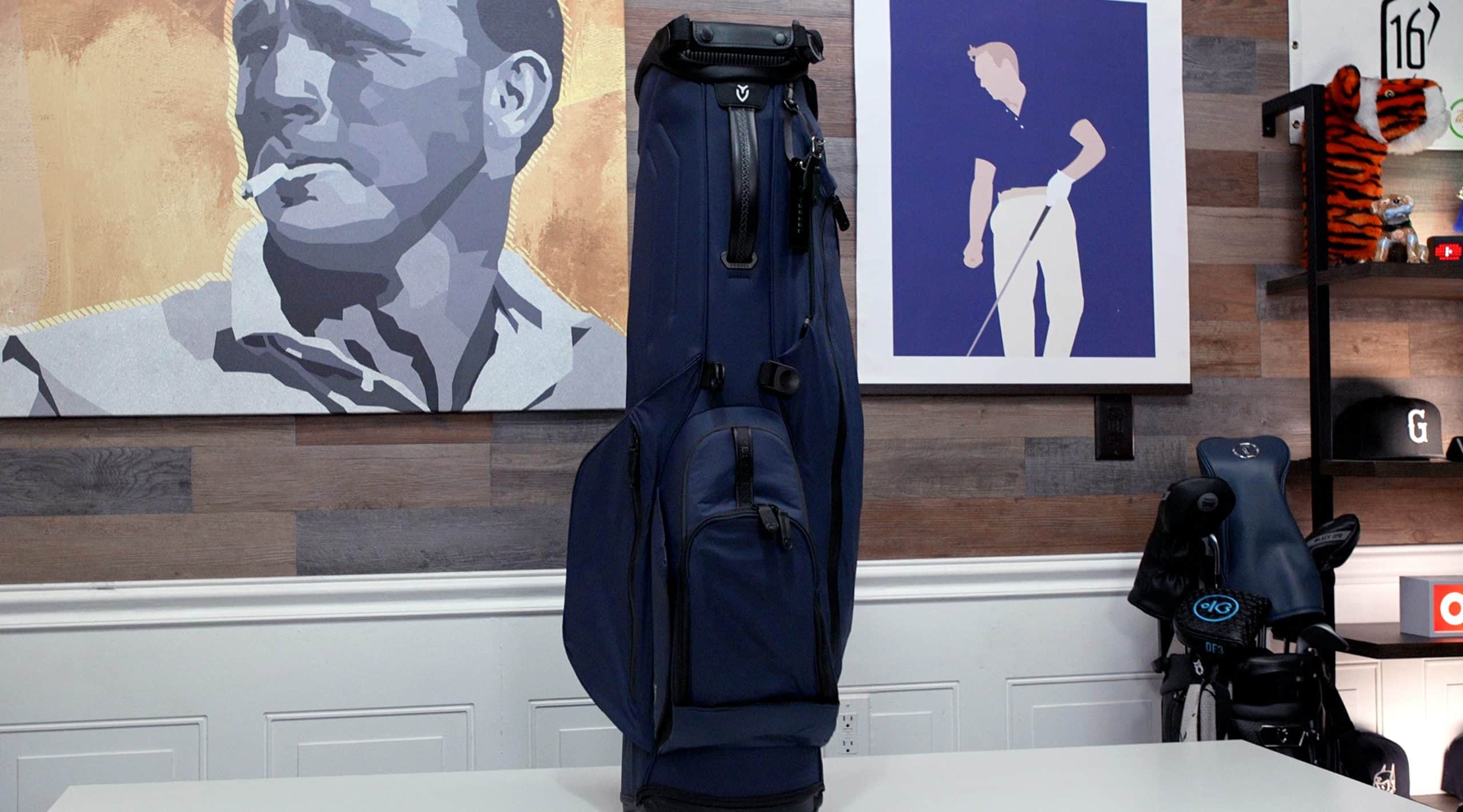 Navy blue golf bag on white table indoors