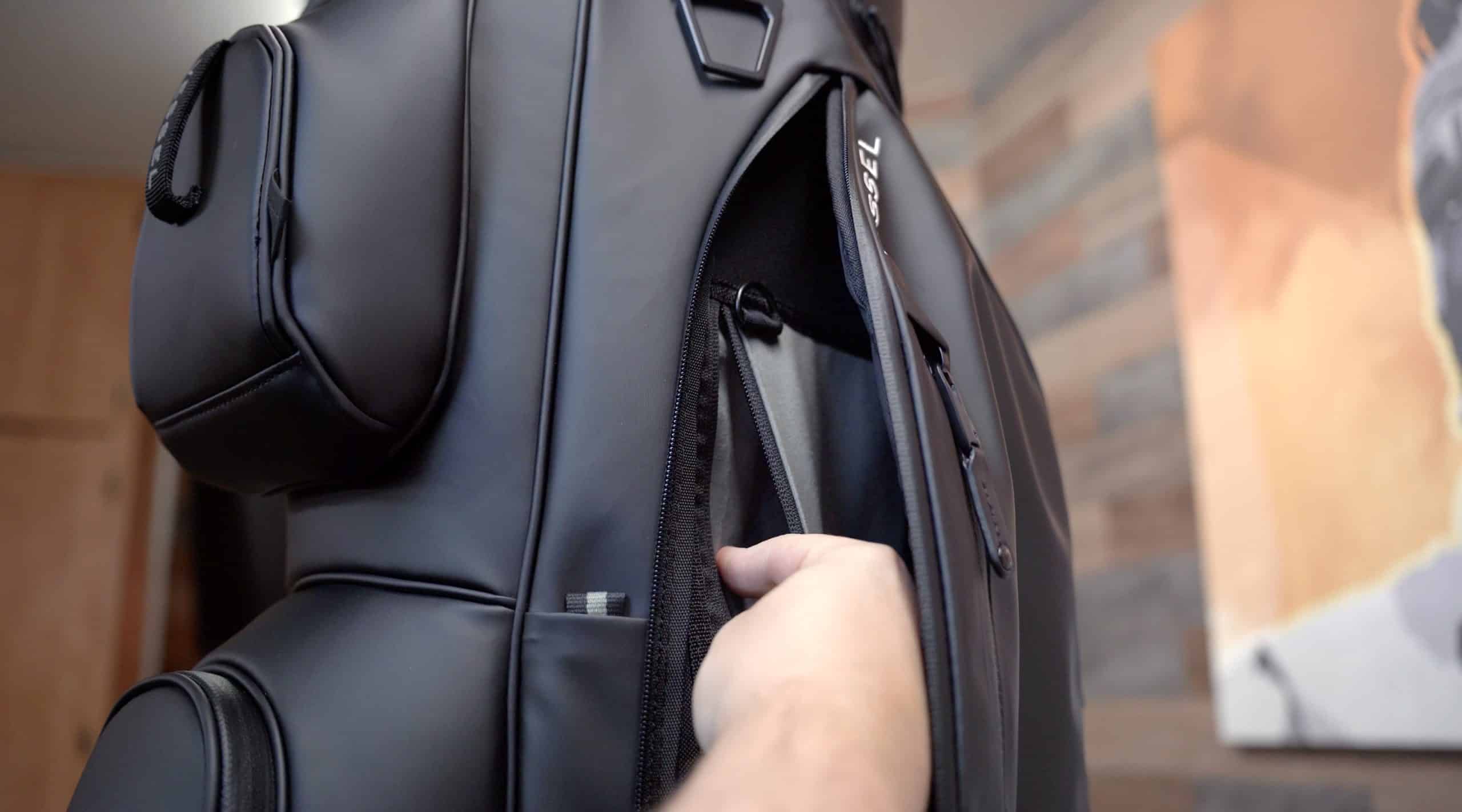 Hand opening black leather golf bag pocket