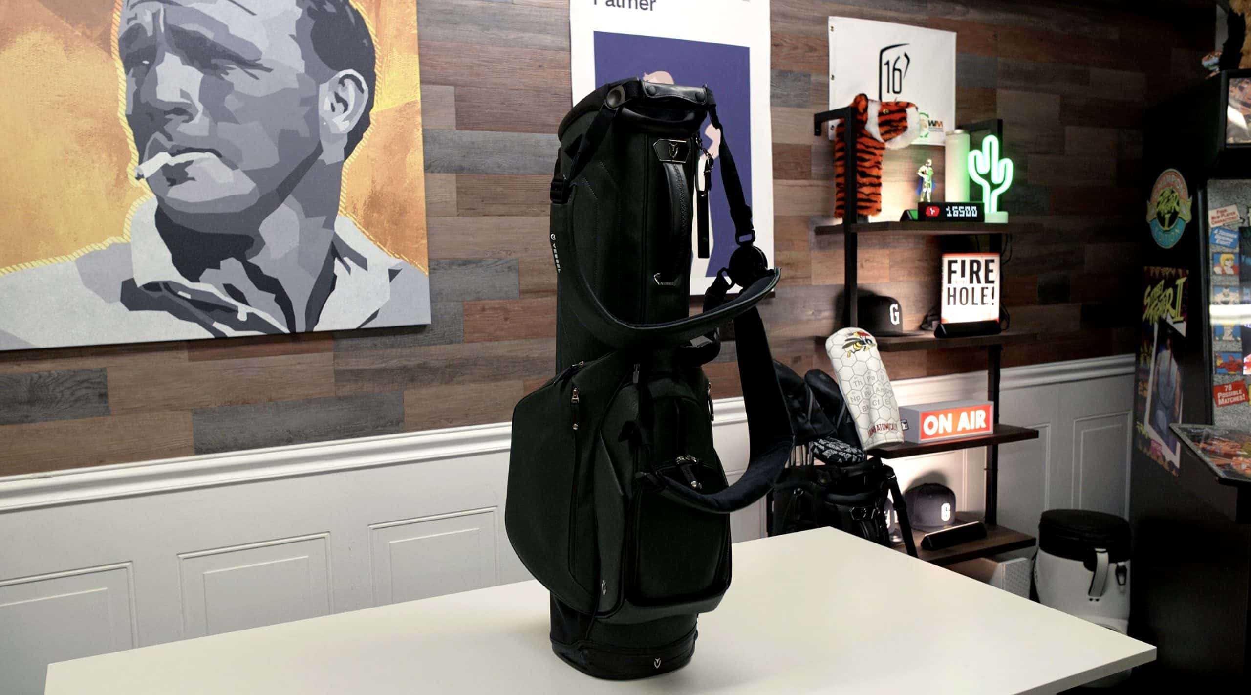 Black golf bag on table in studio