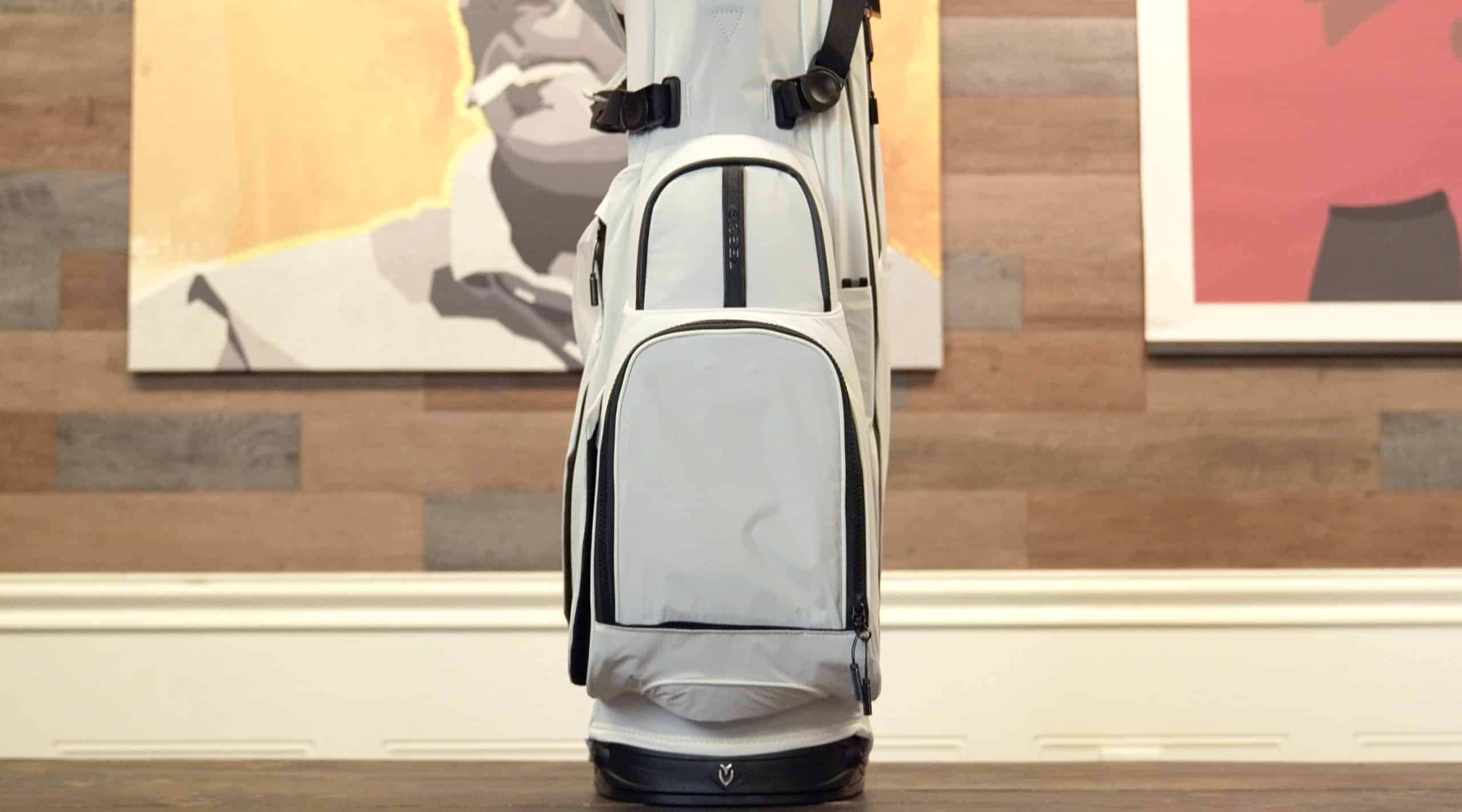 Modern gray golf bag on wooden table